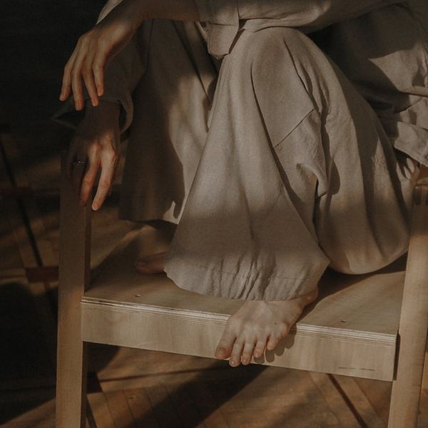 Person meditating peacefully in a sunlit room.